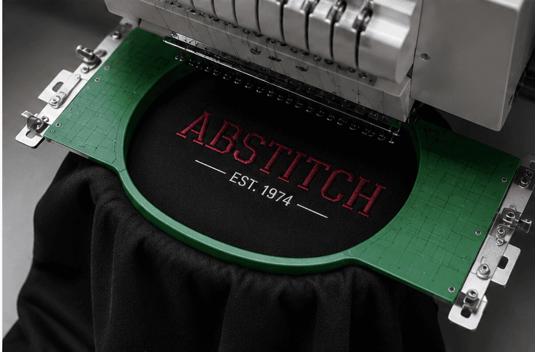 Embroidered Abstitch logo on dark fabric