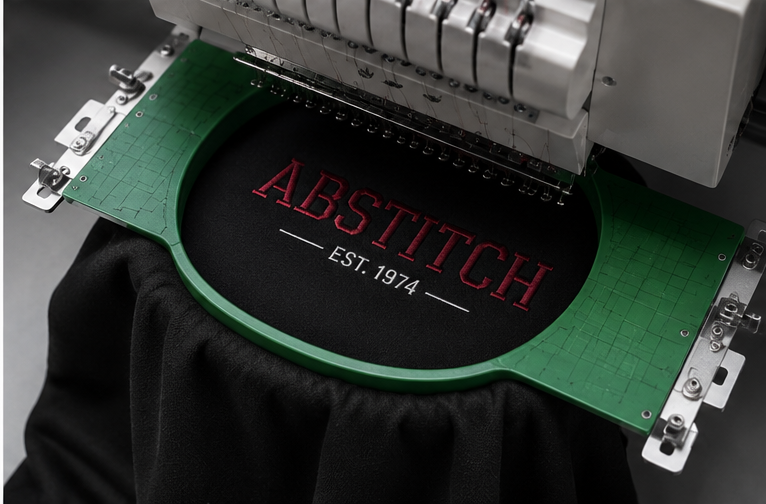 Embroidered Abstitch logo on dark fabric